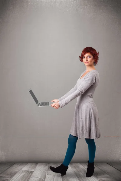 Young woman holding modern laptot — Stock Photo, Image