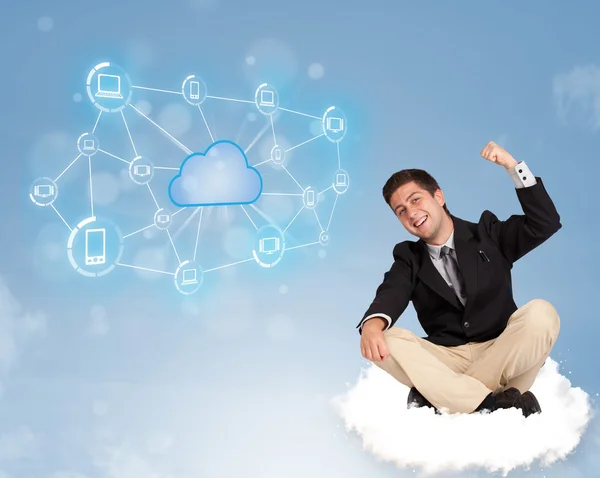 Happy businessman sitting on cloud with cloud computing — Stock Photo, Image