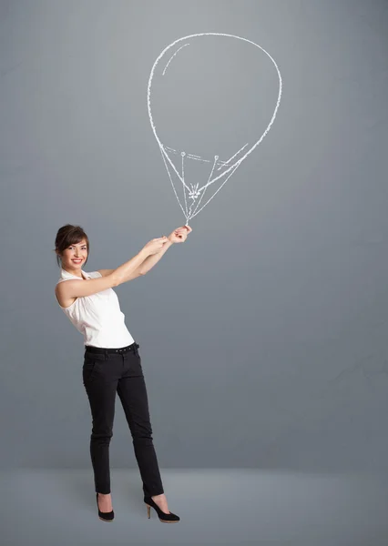 Beautiful woman holding balloon drawing — Stock Photo, Image