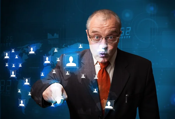 Businessman choosing from social network map — Stock Photo, Image