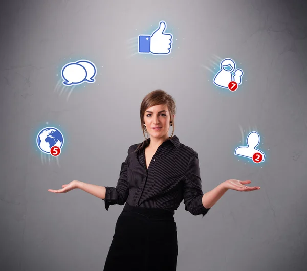 Attractive young woman juggling with social network icons — Stock Photo, Image