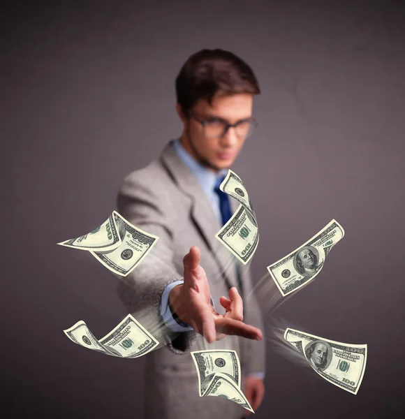 Young man throwing money — Stock Photo, Image