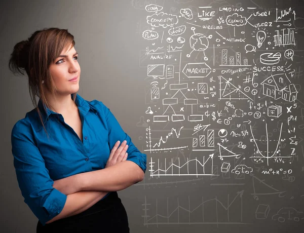 Pretty woman looking at stock market graphs and symbols — Stock Photo, Image