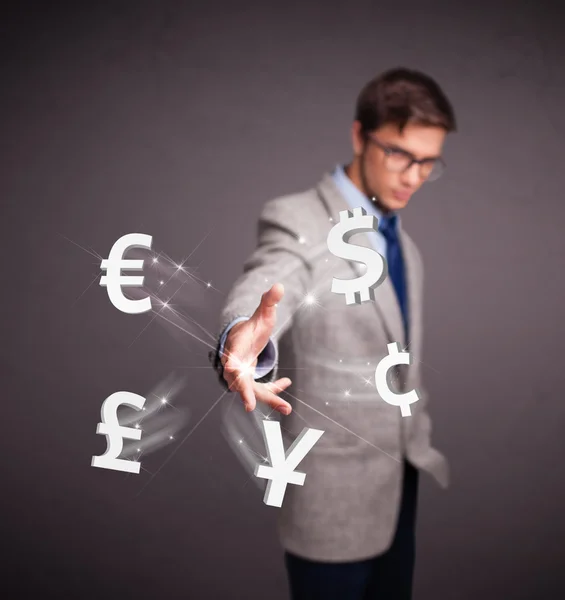 Attractive man throwing currency icons — Stock Photo, Image