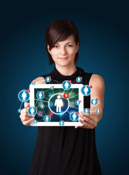 Young woman holding tablet with social network icons — Stock Photo, Image