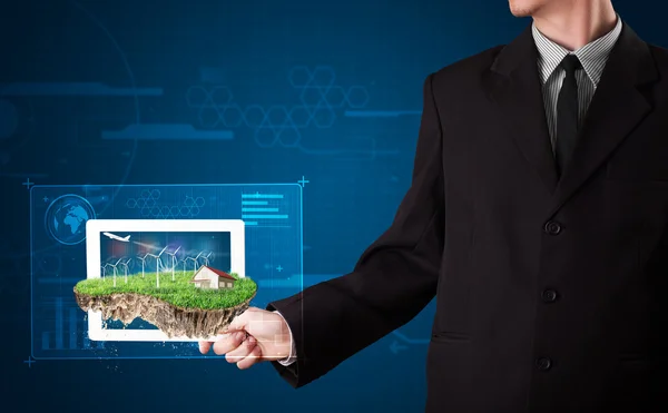 Businessman presenting a perfect ecology land with a house and w — Stock Photo, Image