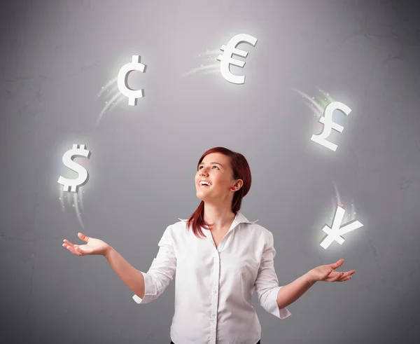 Young lady standing and juggling with currency icons — Stock Photo, Image