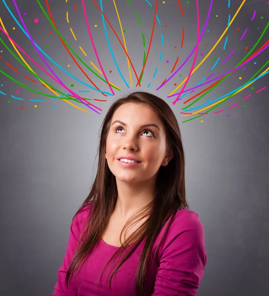 Young girl thinking with colorful abstract lines overhead — Stock Photo, Image