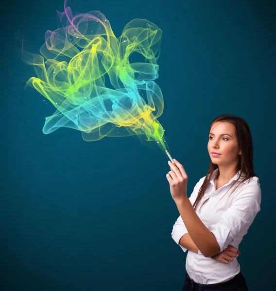 Pretty lady smoking cigarette with colorful smoke — Stock Photo, Image