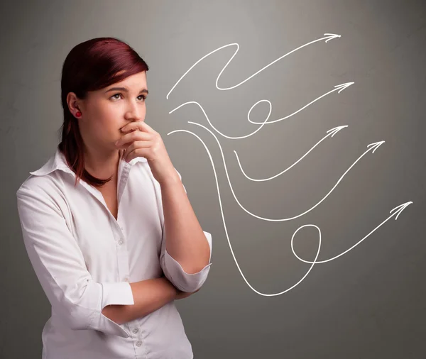 Attractive teenager looking at multiple curly arrows — Stock Photo, Image