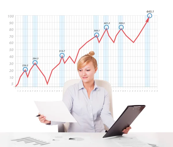 Young businesswoman calculating stock market with rising graph i — Stock Photo, Image