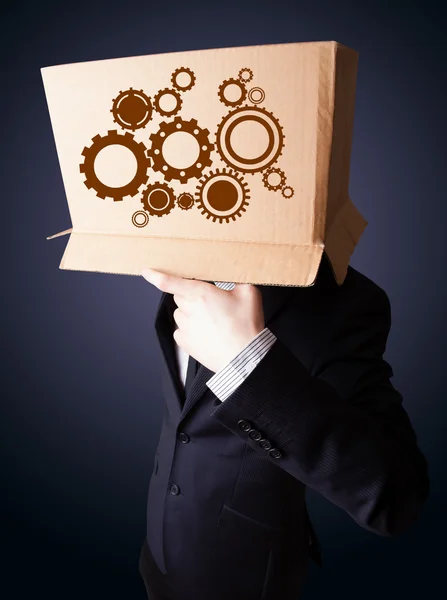 Businessman gesturing with a cardboard box on his head with spur — Stock Photo, Image