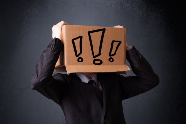 Businessman gesturing with a cardboard box on his head with excl clipart