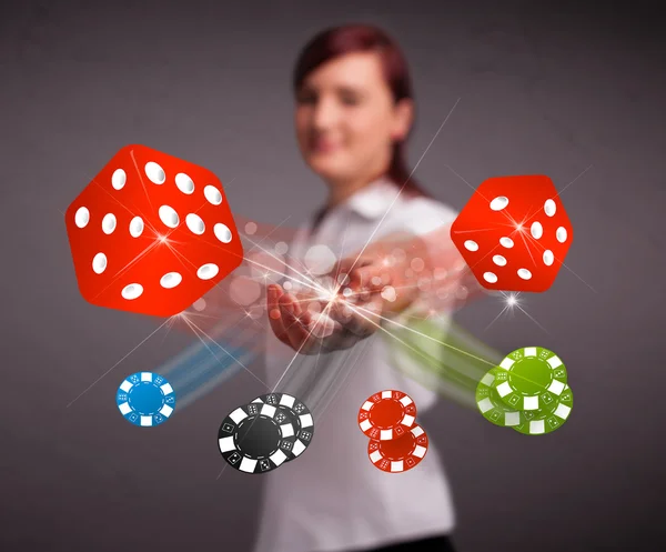 Young woman throwing dices and chips — Stock Photo, Image