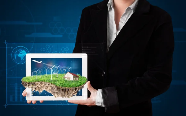 Woman presenting a perfect ecology land with a house and windmil — Stock Photo, Image