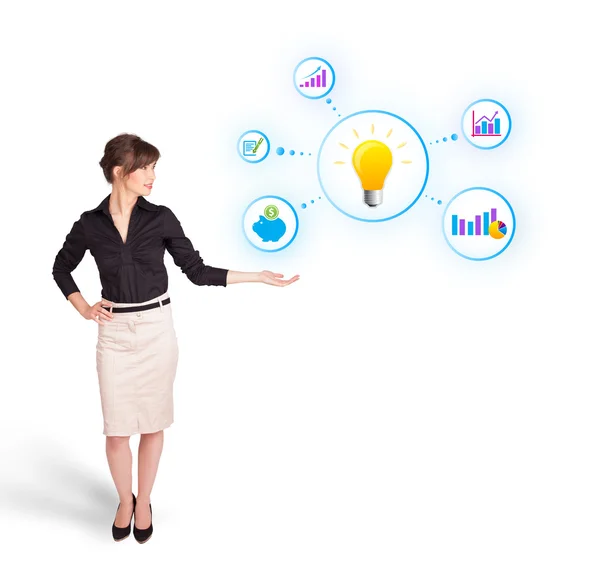 Young woman presenting light bulb with colorful graphs and diagr — Stock Photo, Image