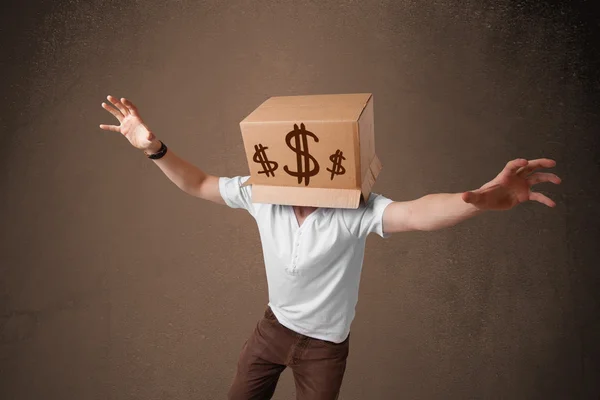 Young man gesturing with a cardboard box on his head with dollar — Stock Photo, Image