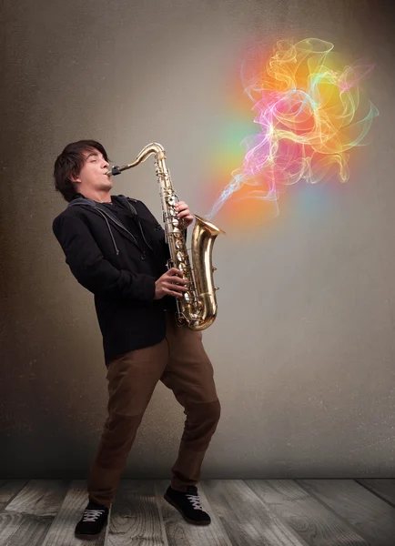Attractive musician playing on saxophone with colorful abstract — Stock Photo, Image