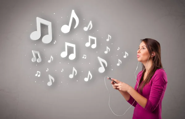 Pretty young woman singing and listening to music with musical n — Stock Photo, Image