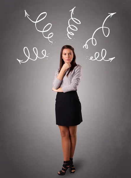 Young woman thinking with arrows overhead — Stock Photo, Image