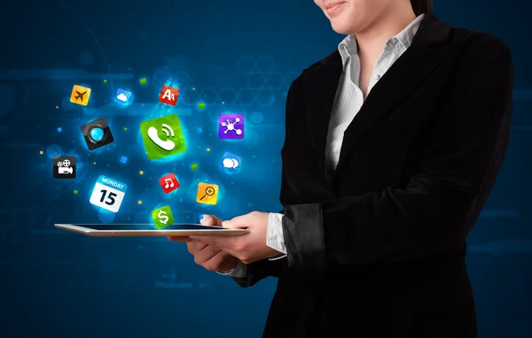 Lady holding a tablet with modern colorful apps and icons — Stock Photo, Image