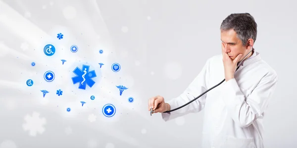 Doctor with blue medical icons — Stock Photo, Image