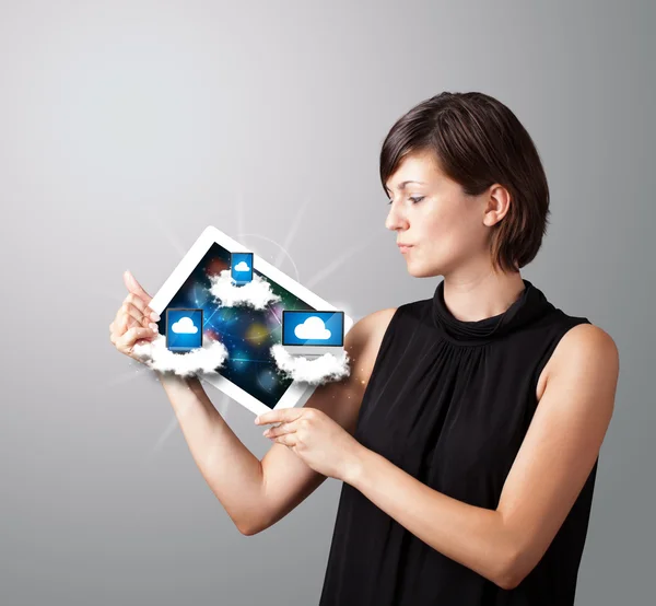 Young woman holding tablet with modern devices in clouds — Stock Photo, Image