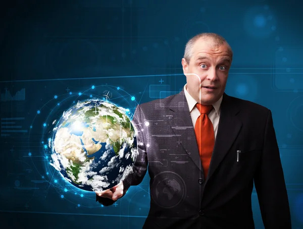 Businessman touching high-tech 3d earth panel — Stock Photo, Image