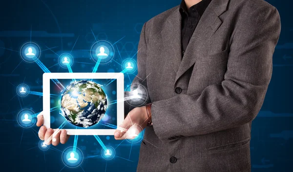 Businessman presenting 3d earth globe in tablet — Stock Photo, Image