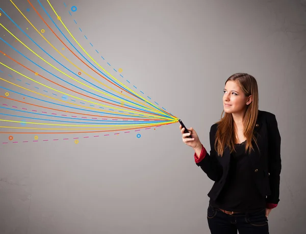 Happy girl holding a phone with colorful abstract lines — Stock Photo, Image