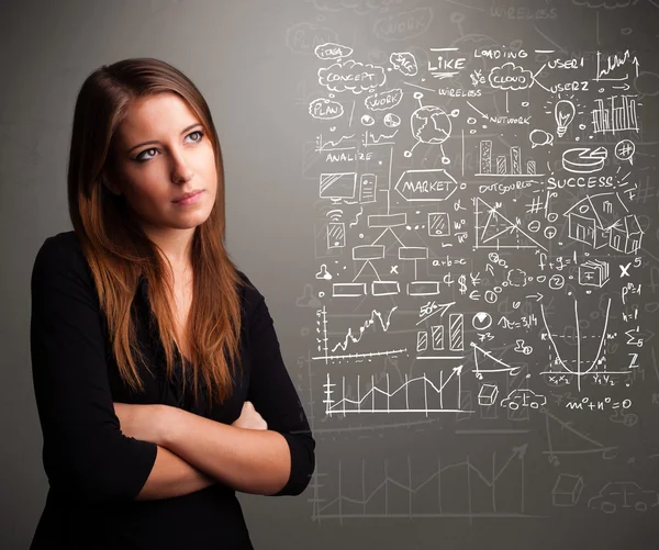 Pretty woman looking at stock market graphs and symbols — Stock Photo, Image