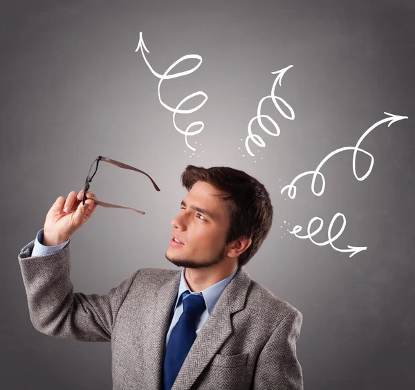 Young man thinking with arrows overhead — Stock Photo, Image