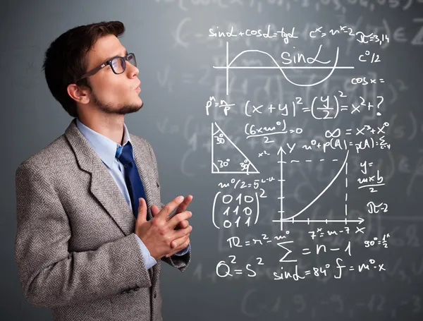 Handsome school boy thinking about complex mathematical signs — Stock Photo, Image