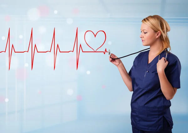 Young nurse listening to abstract pulse with red heart — Stock Photo, Image