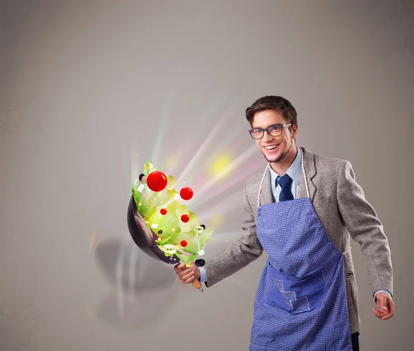 Young man cooking fresh vegetables — Stock Photo, Image