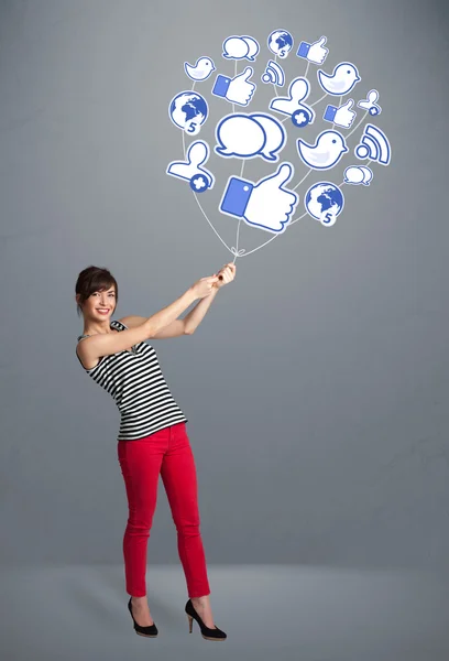 Pretty woman holding social icon balloon — Stock Photo, Image