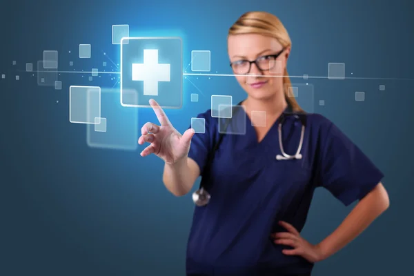 Young nurse pressing modern medical type of buttons — Stock Photo, Image