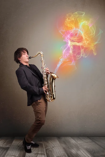 Attractive musician playing on saxophone with colorful abstract — Stock Photo, Image