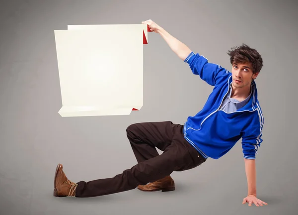 Young man holding white origami paper copy space — Stock Photo, Image