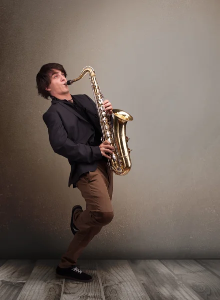 Young musician playing on saxophone — Stock Photo, Image