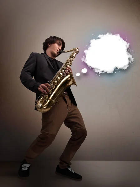 Young man playing on saxophone with copy space in white cloud — Stock Photo, Image