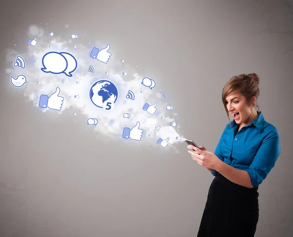 Pretty young girl holding a phone with social media icons — Stock Photo, Image