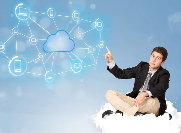 Happy businessman sitting on cloud with cloud computing — Stock Photo, Image
