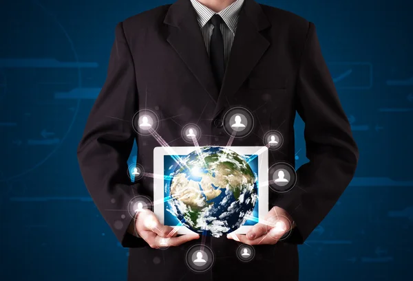 Businessman presenting 3d earth globe in tablet — Stock Photo, Image