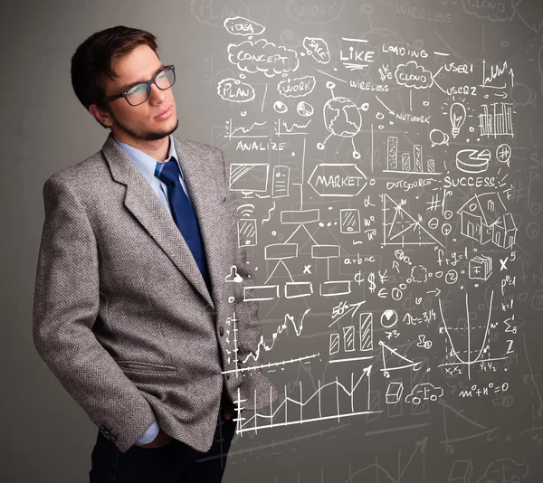 Uomo attraente guardando grafici e simboli del mercato azionario — Foto Stock