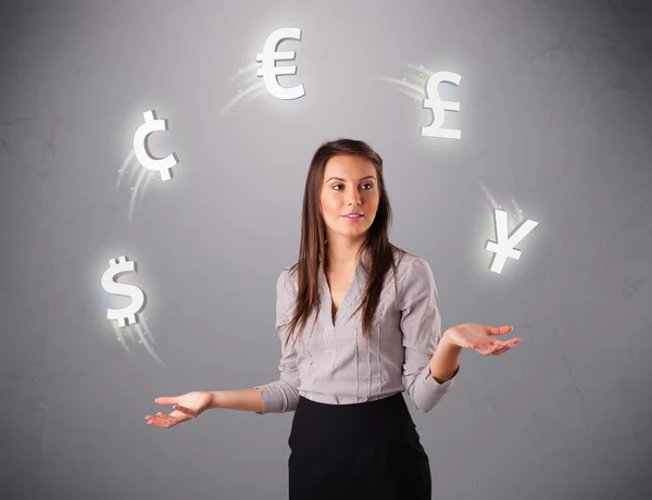 Young lady standing and juggling with currency icons — Stock Photo, Image