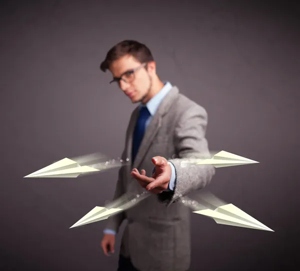 Handsome man throwing origami airplanes — Stock Photo, Image