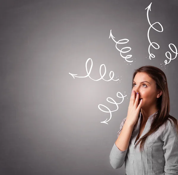 Young woman thinking with arrows overhead — Stock Photo, Image