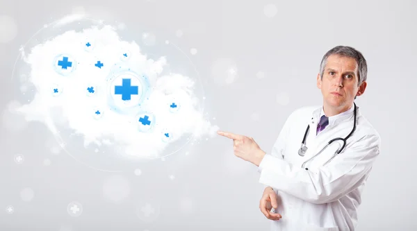 Doctor listening to abstract cloud with medical signs — Stock Photo, Image