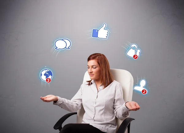 Attractive young woman juggling with social network icons — Stock Photo, Image